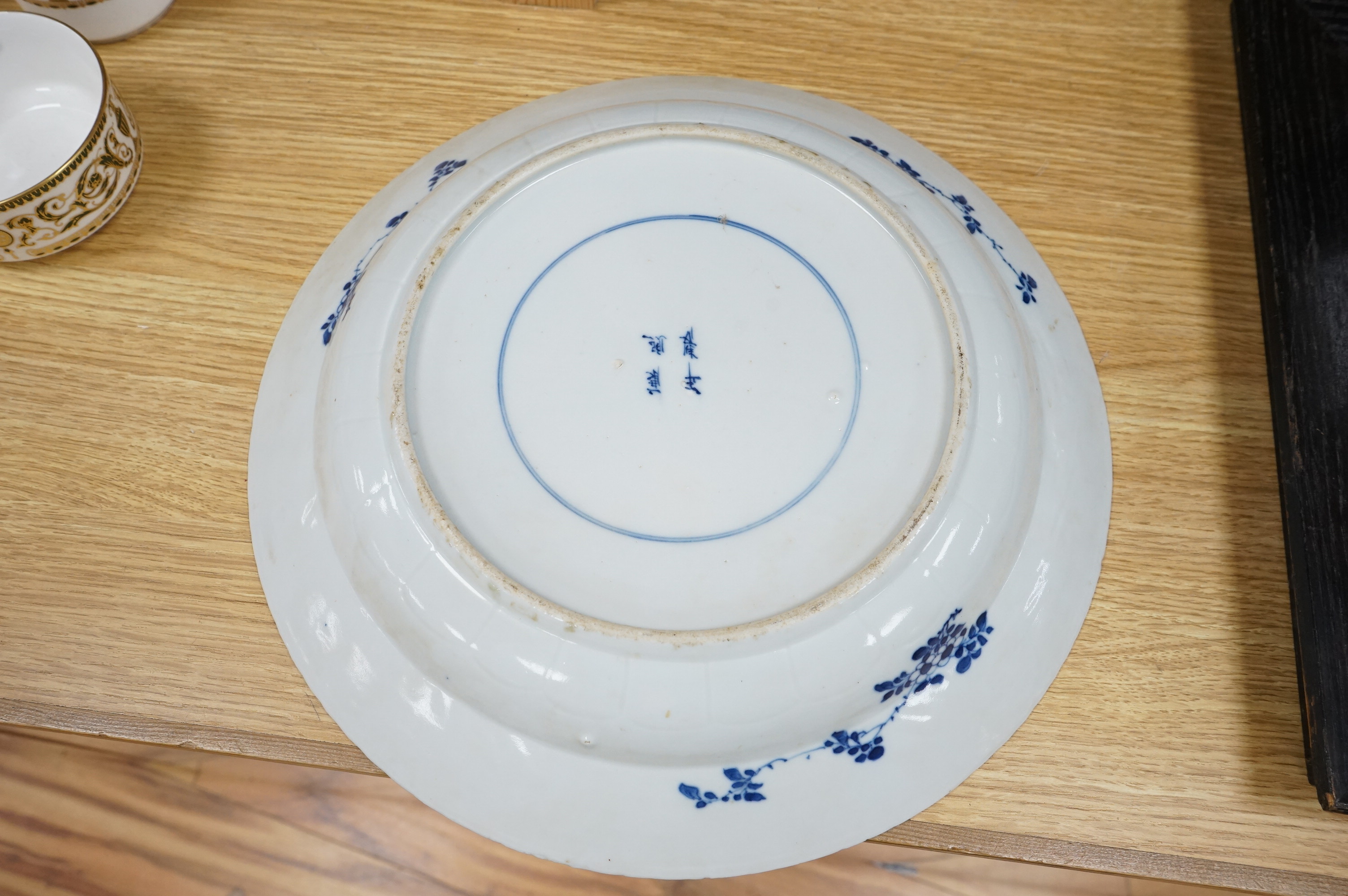 A Chinese blue and white 'fish' dish, Kangxi mark but c.1900, 33cm diameter. Condition - slight chipping to rim